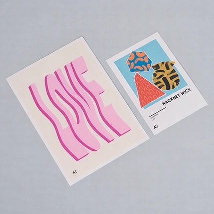 Two art prints: one with "LOVE" in pink wavy letters, one with abstract shapes labeled "HACKNEY WICK.