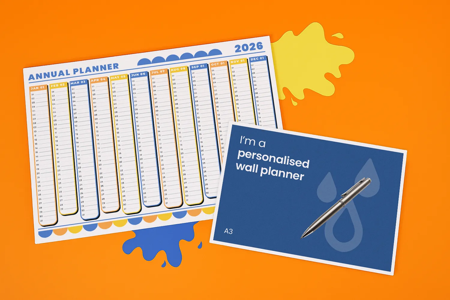 Two wall planners and a pen are arranged on a bright orange background.