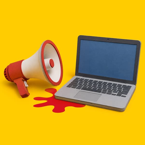 A laptop and a megaphone sit on a yellow background with a red splash shape nearby.