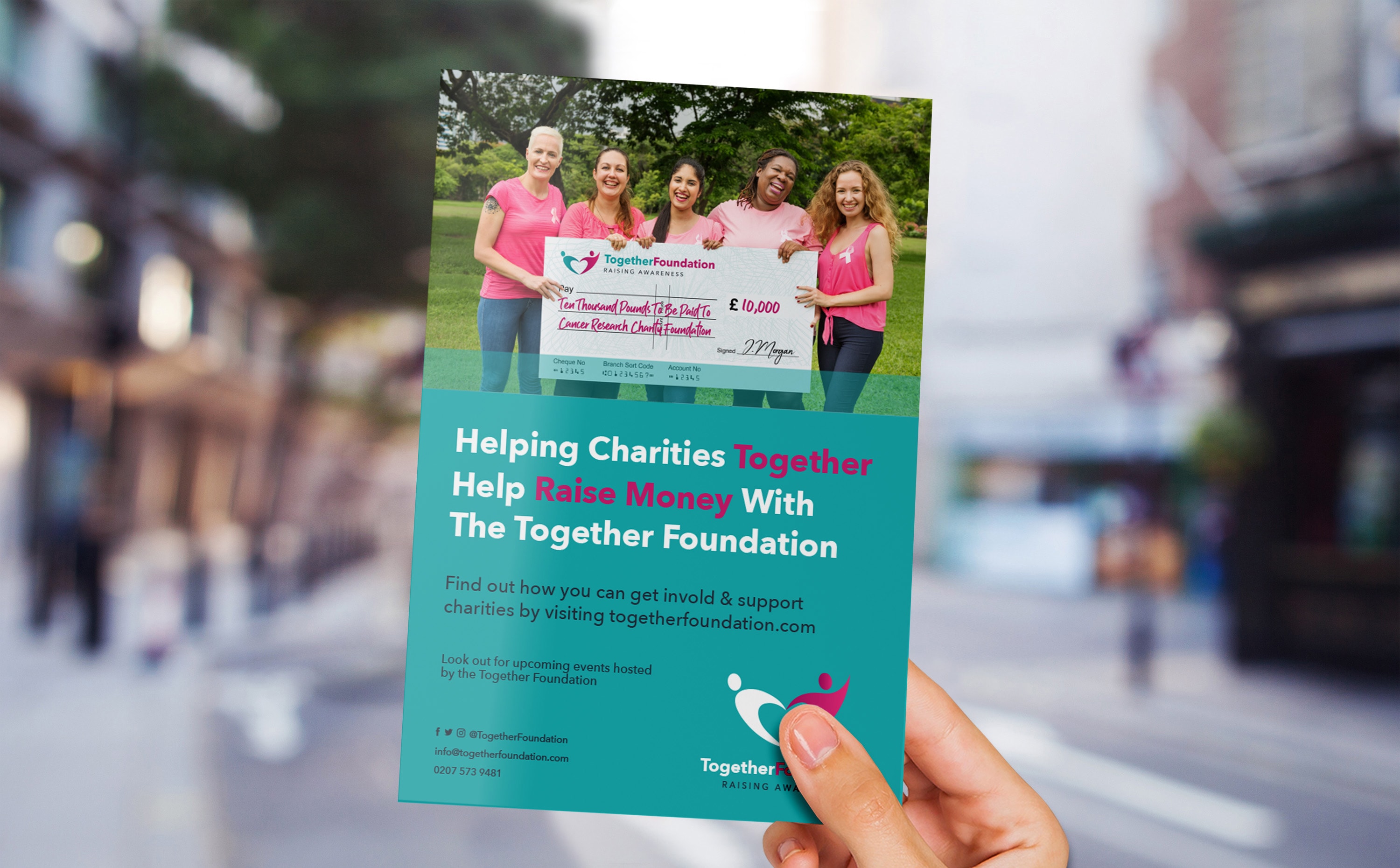 Person holding flyer advertising The Together Foundation charity fundraising event in a park.