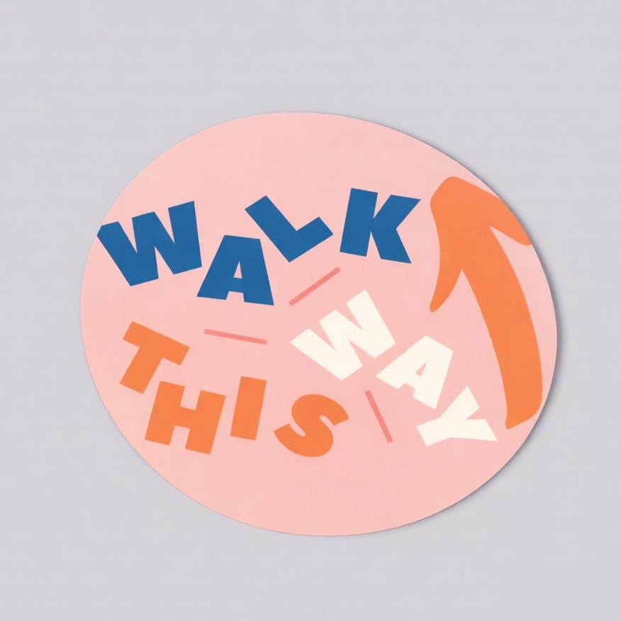 A pink circle floor sticker reads "WALK THIS WAY" with an arrow pointing to the upper right.