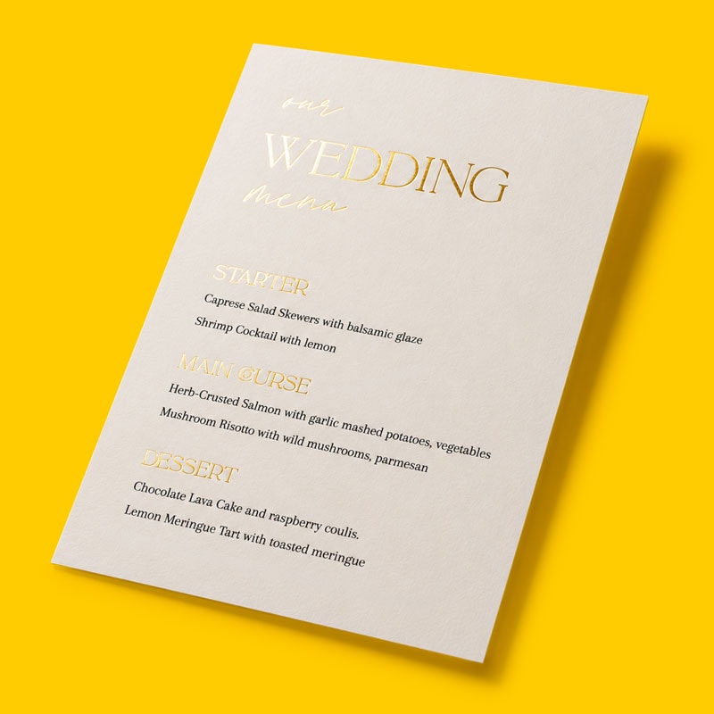 A wedding menu card listing starter, main course, and dessert options on a yellow background.
