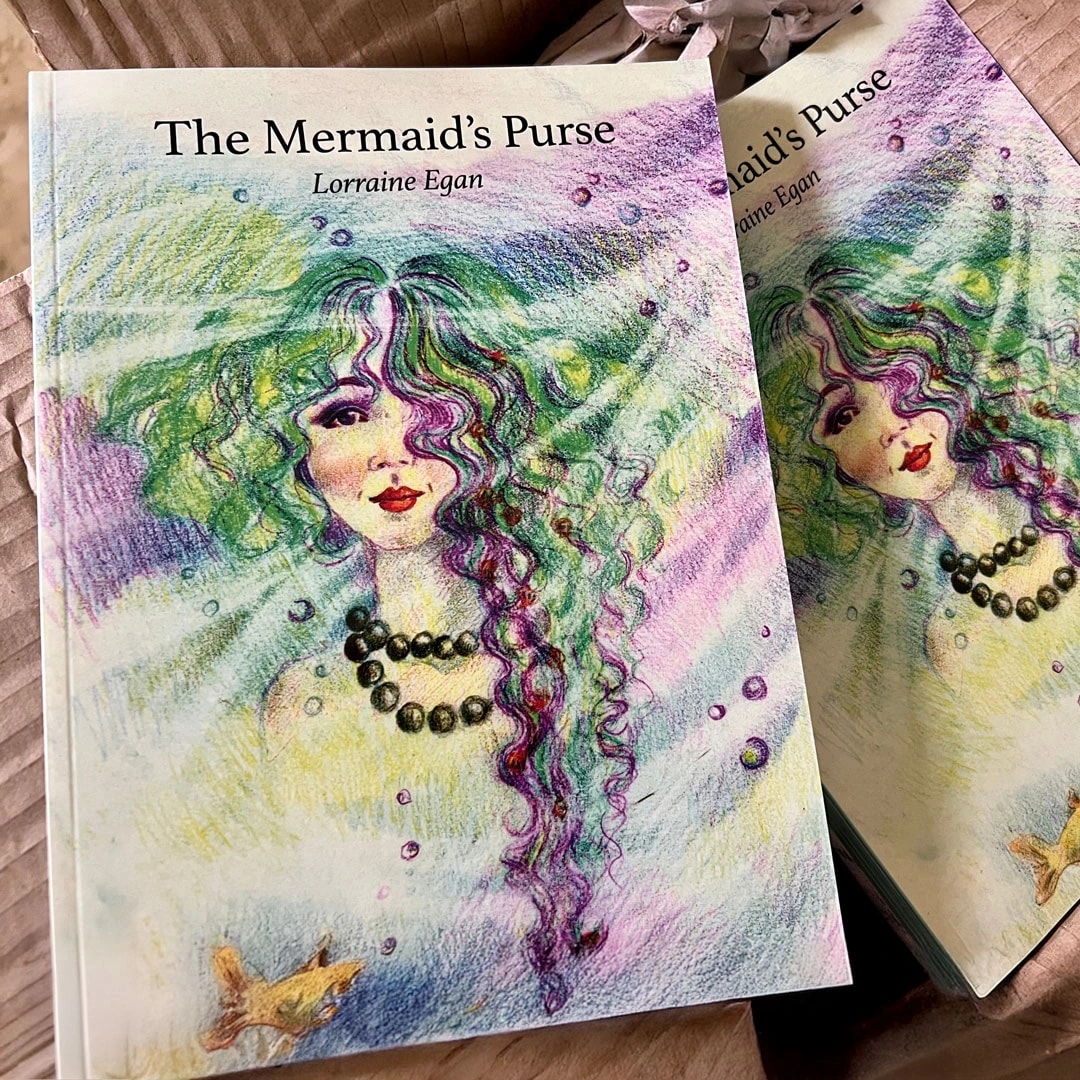 Book titled "The Mermaid’s Purse" by Lorraine Egan with an illustrated mermaid on the cover.