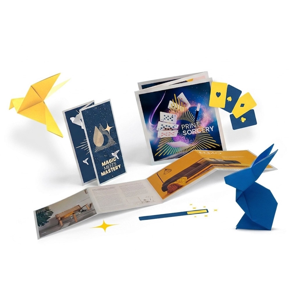 Magic kit with instruction booklets, playing cards, origami figures, and a magic wand.
