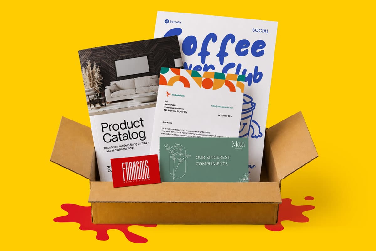 An open box containing printed catalogs, cards, and a Coffee Lover Club poster on a yellow background.