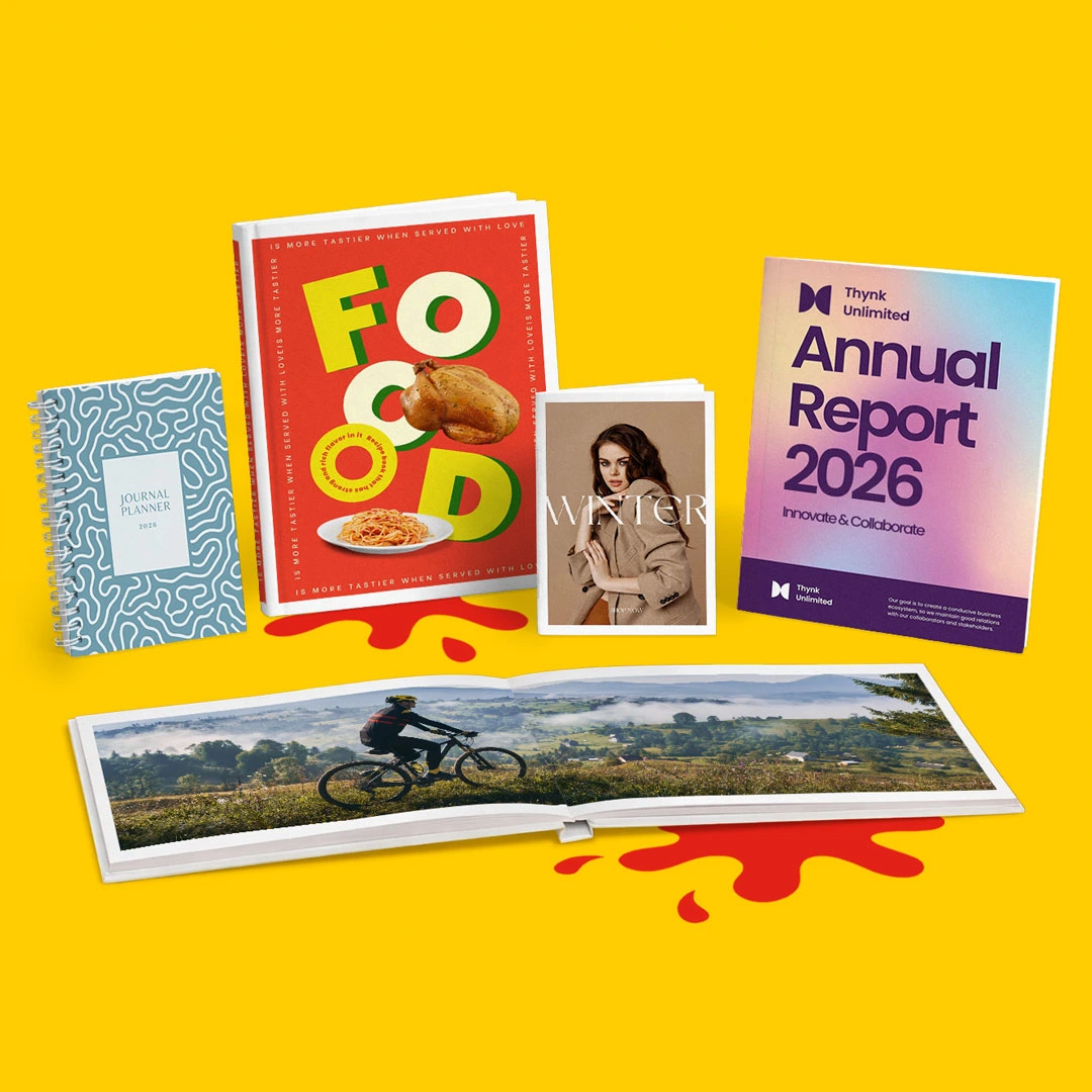 Five assorted books and magazines displayed upright and open on a yellow background.