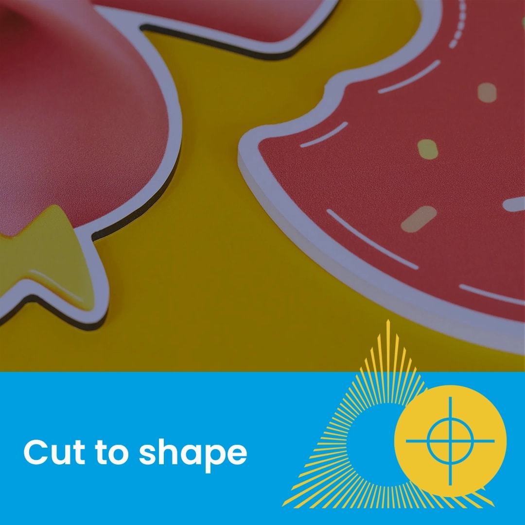 Close-up of colourful cut-out shapes on a yellow surface with text "Cut to shape" below.