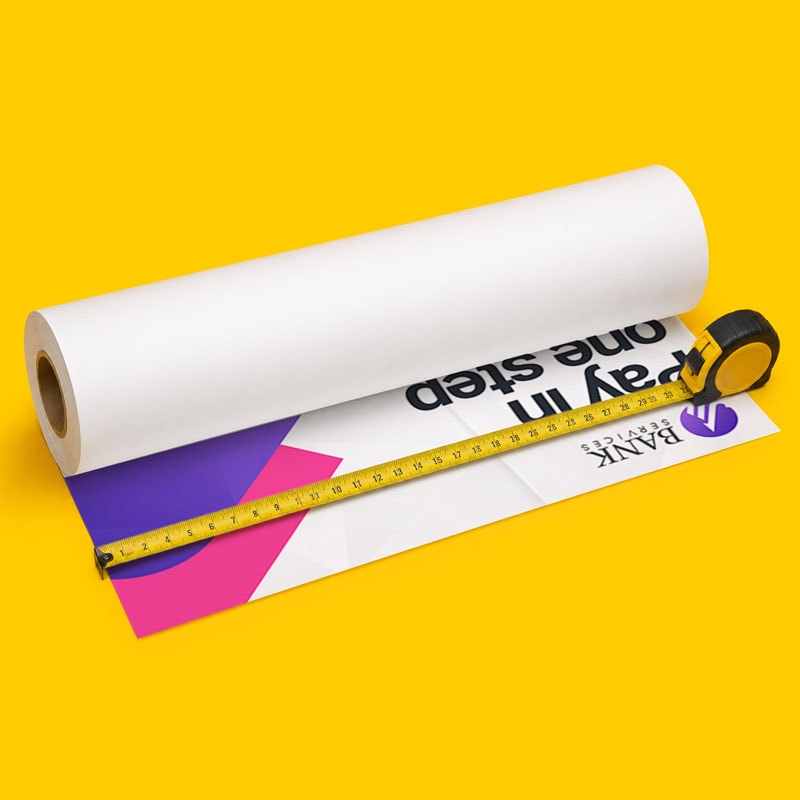 A roll of white paper with a yellow tape measure placed across it on a yellow background.