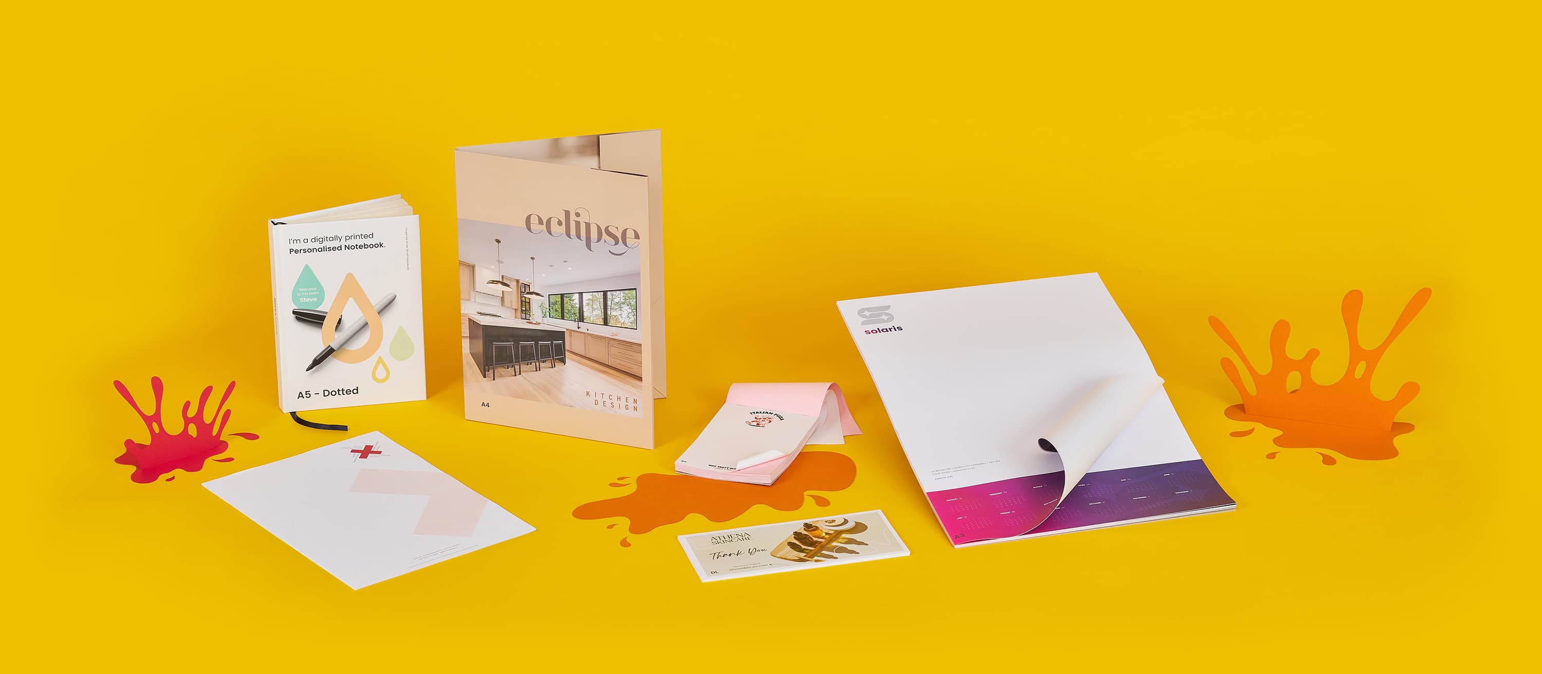 Assorted colourful brochures and cards on a yellow background.